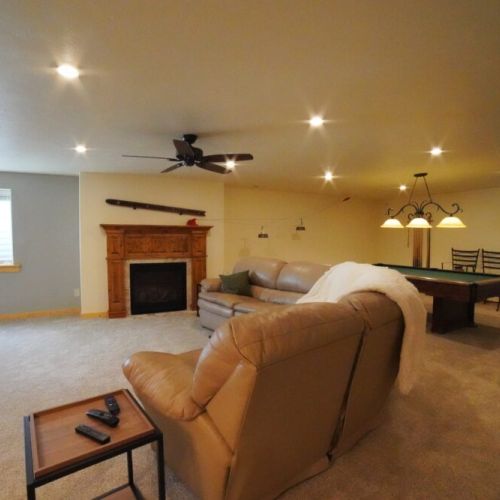 In the basement is another living space, complete with a bar, gas fireplace, and pool table.