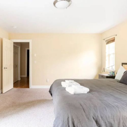 The master bedroom features a king bed, a large en suite bathroom, and direct access to the back porch.