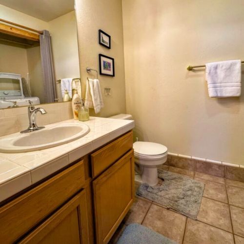 There is a half-bath on the main level, between the kitchen and living room. This is also where the laundry is located.