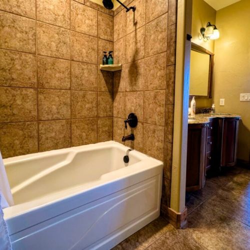 The en suite bath comes with a double vanity, large tub/shower combo, and a spacious closet.