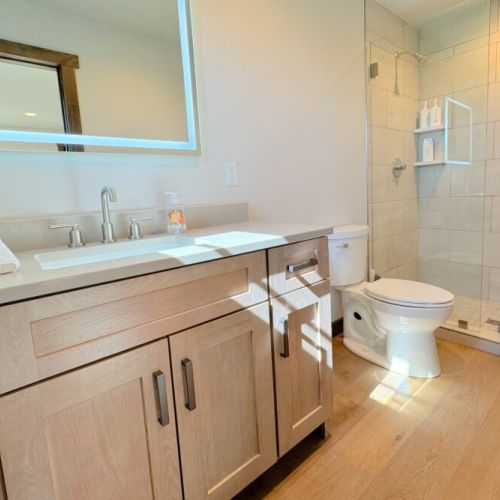 Bedroom #3's en suite has a walk-in shower and a vanity.