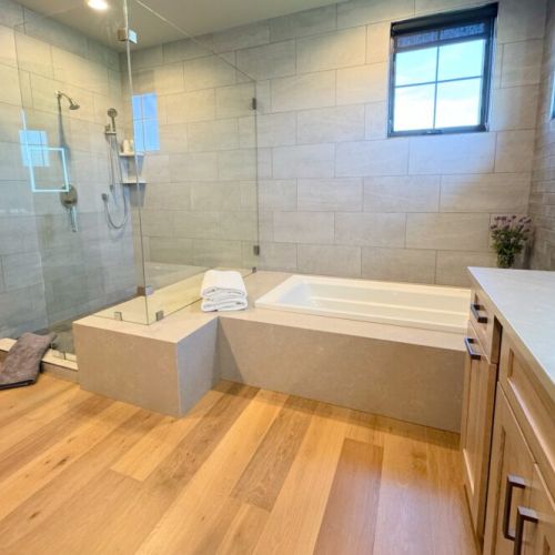 The primary en suite enjoys a large walk-in shower, a soaking tub, and a spacious double vanity.