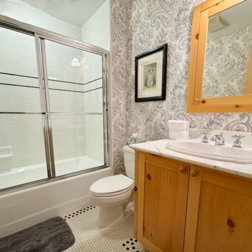 Bedrooms #3 and #4 share a full bath upstairs, which features a walk-in shower.