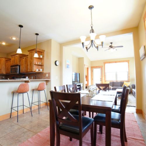 Whether you are chatting at the kitchen island, sitting at the table, or lounging in the living room, you are always a part of the fun in this condo.