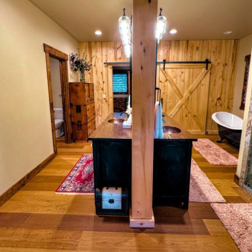 The master bath has a walk-in shower with his-and-hers shower heads. There is also a beautiful tub, three sinks, and plenty of space to store toiletries or other items.