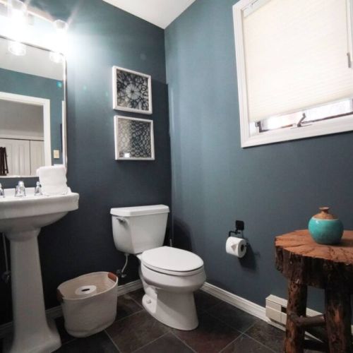 The powder room is conveniently located next to the entryway, just off the living room.