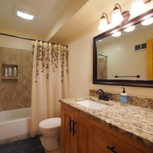 Bedrooms #4 and #5 share a full bathroom, which is located off the downstairs living area.