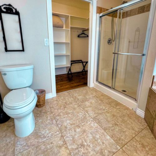The primary en suite enjoys a large vanity, a luxurious jetted tub, and access to the walk-in closet.