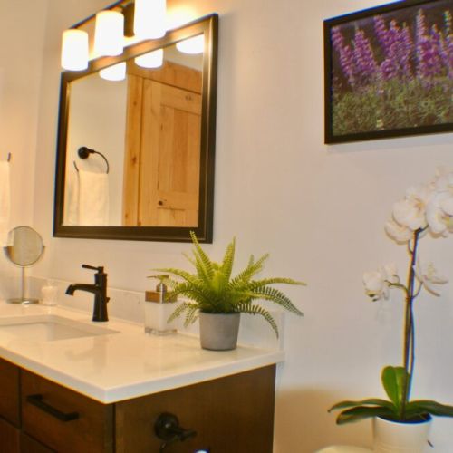 The upstairs bedrooms share a bathroom, which features a vanity and a large tub/shower combo.