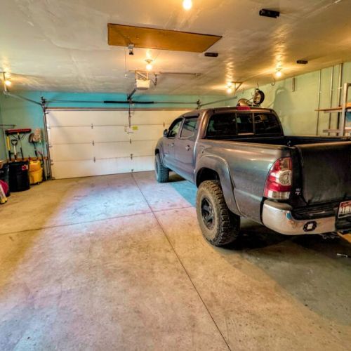 Keep your gear and your car dry using the available garage stall. (The owner stores his truck year-round on the other side.)