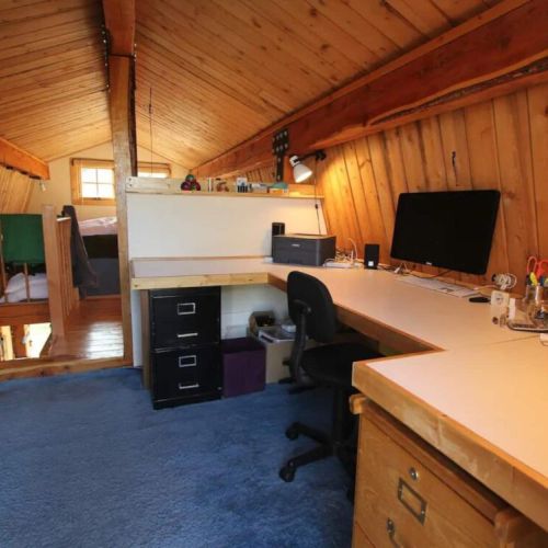 The office is separated from the bedroom by a catwalk with railings. (The computer is not included, but WiFi is!)
