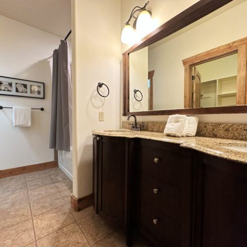 The master en suite bathroom has a large tub/shower combo, a spacious double vanity, and a private water closet.