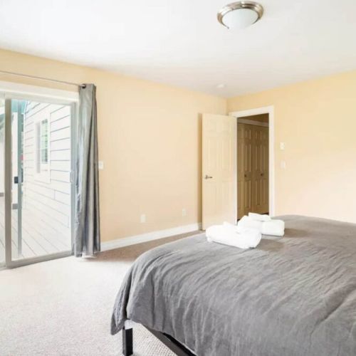 The master bedroom features a king bed, a large en suite bathroom, and direct access to the back porch.