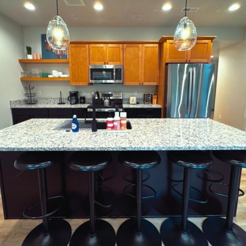 The kitchen island is the perfect spot to prepare a meal, enjoy a drink, or hangout with friends and family.