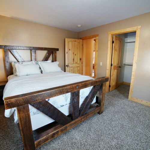 Bedroom #3 on the main floor also enjoys a great queen bed with a custom-made wood frame, as well as a spacious closet.