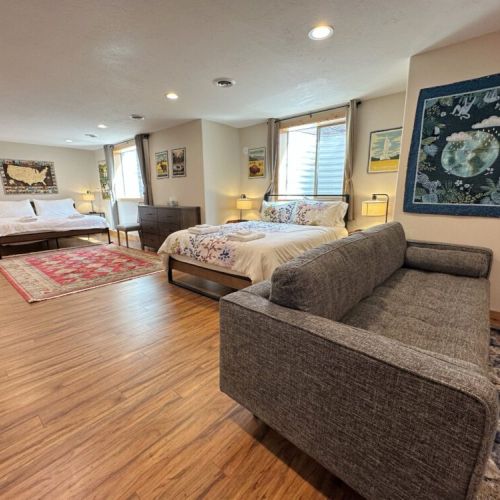 Two beds are in the shared living space — one queen and one king.