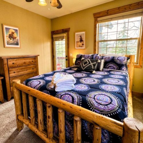 Bedroom #2 has a comfy queen bed with a large closet, a set of drawers, and great natural light.