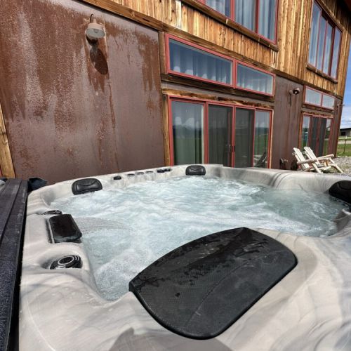 The hot tub is out on the back porch, making it easily accessible from any room in the house.