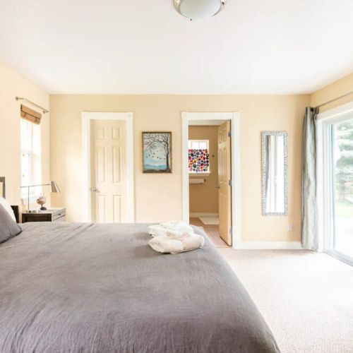 The master bedroom features a king bed, a large en suite bathroom, and direct access to the back porch.