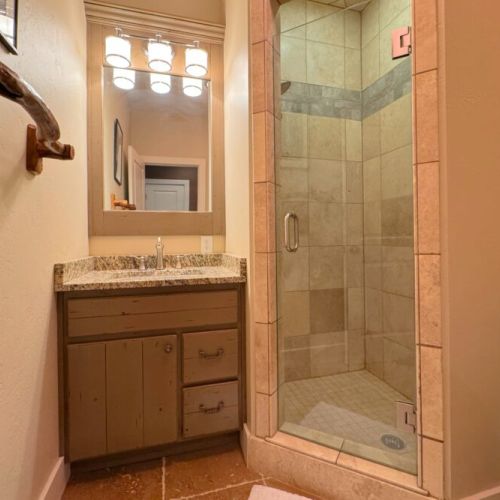 Bedrooms #4 and #5, as well as the kid's play room, share a 3/4 bath that features a walk-in shower and a cozy vanity.