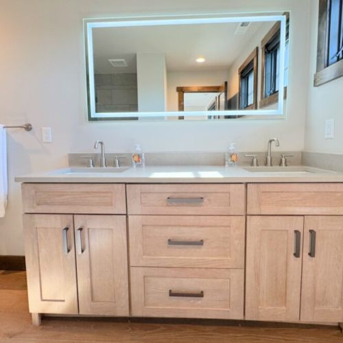 The Jack-and-Jill-style bathroom features a double vanity and a walk-in shower.