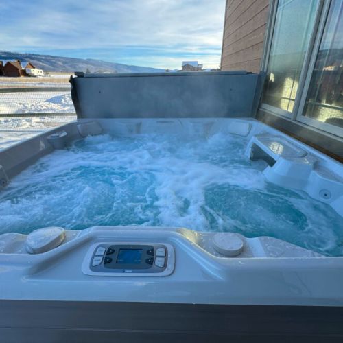 The brand-new hot tub makes for an inviting way to begin or end any day at this home.