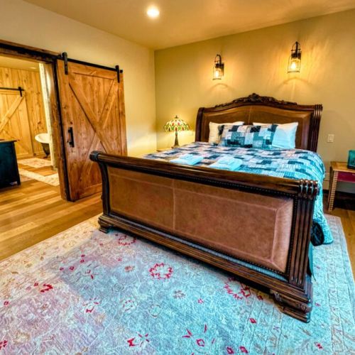The master bedroom has a king bed and a huge en suite bath, as well as a large wardrobe, a TV, and a beautiful view of the Tetons.