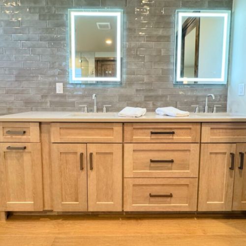 The primary en suite enjoys a large walk-in shower, a soaking tub, and a spacious double vanity.