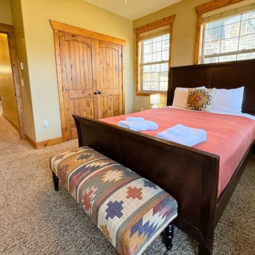 Bedroom #2 has a queen bed, large closet, great natural light, and a door out to one of the condo's two decks.