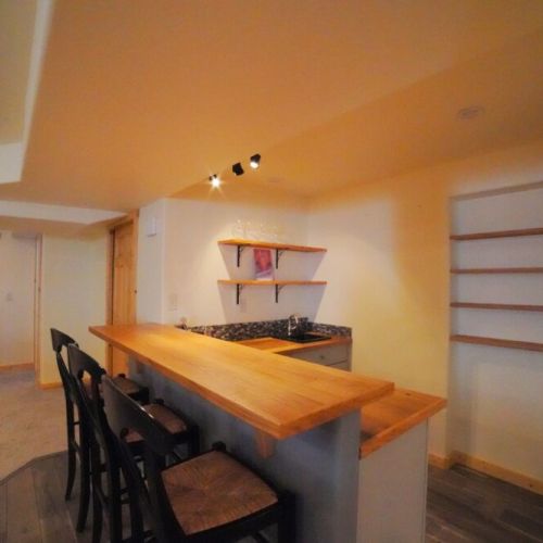 In the basement is another living space, complete with a bar, gas fireplace, and pool table.