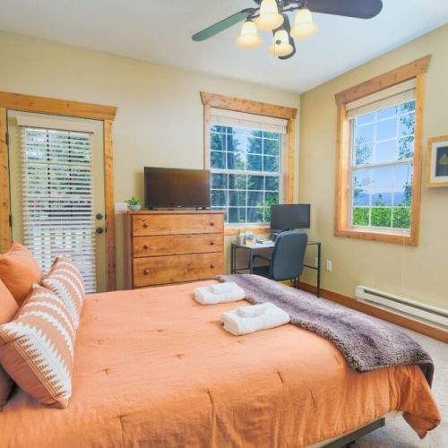 Bedroom #2 has a comfy queen bed with a set of drawers, great natural light, a large closet, and its own desk/monitor.