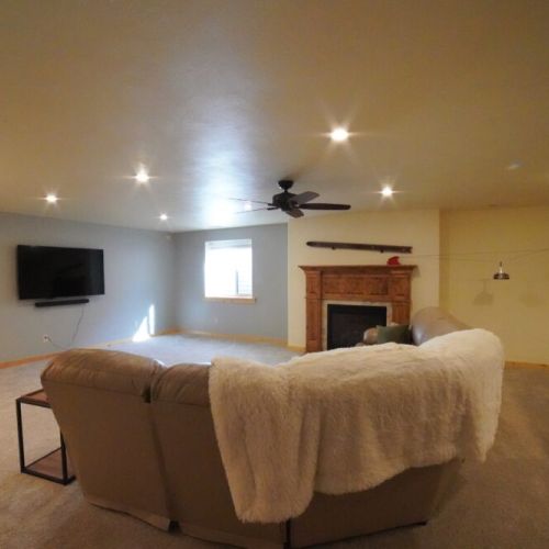 In the basement is another living space, complete with a bar, gas fireplace, and pool table.