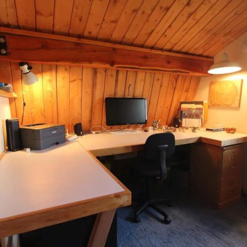 The office loft features a wrap desk and door out to the deck, which overlooks the valley. (The computer is not included, but WiFi is!)