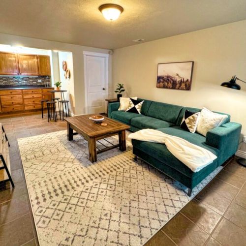 The basement game room comes equipped with a smart TV, a dry bar, and an air hockey table.