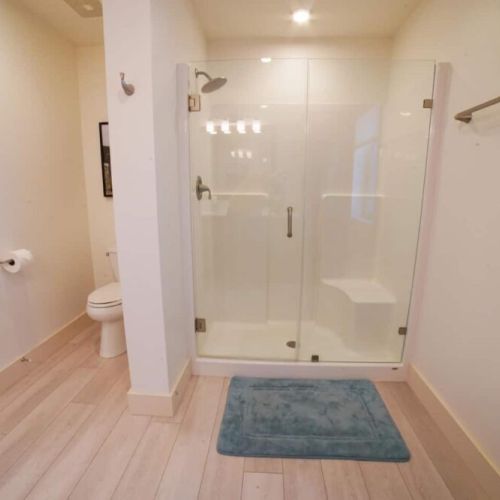 The en suite bath enjoys a spacious vanity and a walk-in shower.