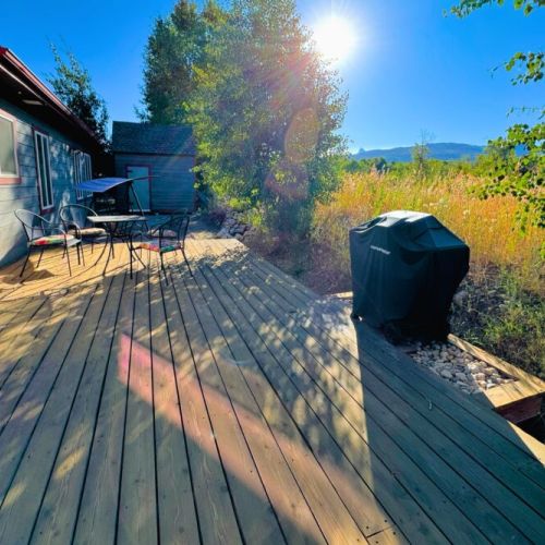 The backyard, which butts up against Ski Hill Road, has a cozy porch with a propane grill and comfy seating options.
