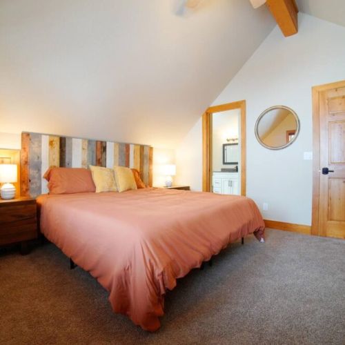 This upstairs bedroom has a king bed and direct access to the upstairs bathroom.