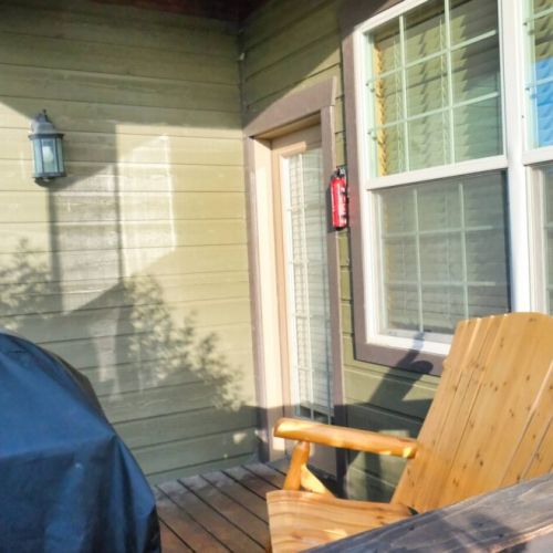On the porch off the living room, make use of a propane grill or relax on a two-seat wood rocker.