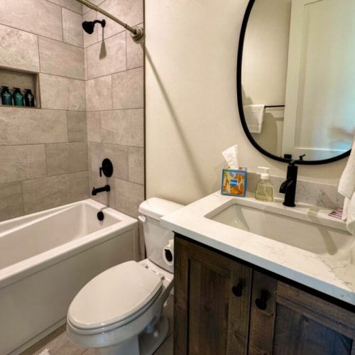 Bedroom #3's en suite also has a vanity and a tub/shower combo.