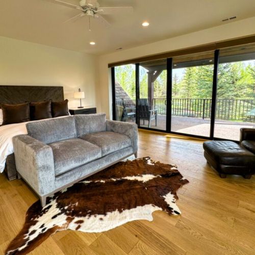 Bedroom #4 (upstairs) is functionally another master! It comes with a king bed, a love seat, a TV, a large en suite, as well as a fantastic balcony overlooking the backyard.