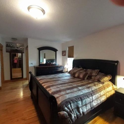 The master bedroom has a king bed and an en suite bath, as well as its own TV.