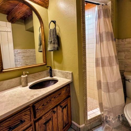There is a full bathroom just off the kitchen, complete with a walk-in shower and vanity.