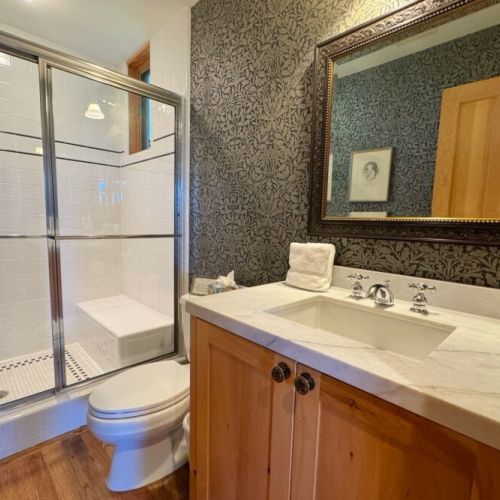 There is a full bathroom on the main level of the home, located just off the kitchen.