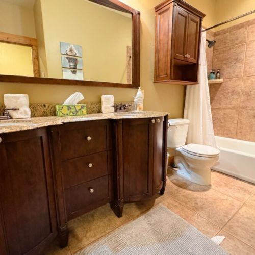 This bathroom, shared by bedrooms #2 and #3, has large tub/shower combo and a double vanity.