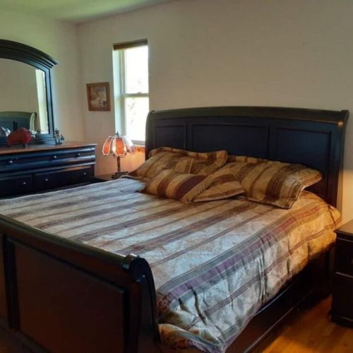 The master bedroom has a king bed and an en suite bath, as well as its own TV.