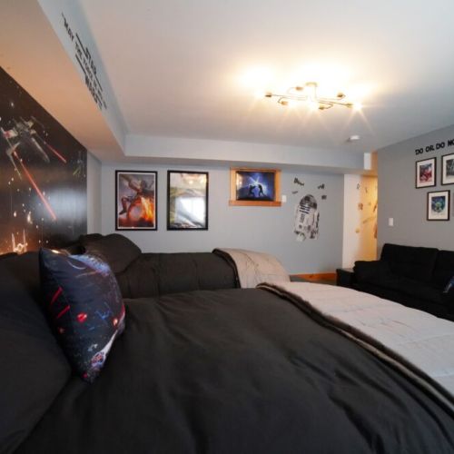The second of two downstairs bedrooms features a "Star Wars" theme — there are two full beds and a pull-out couch, meaning plenty of sleeping space!