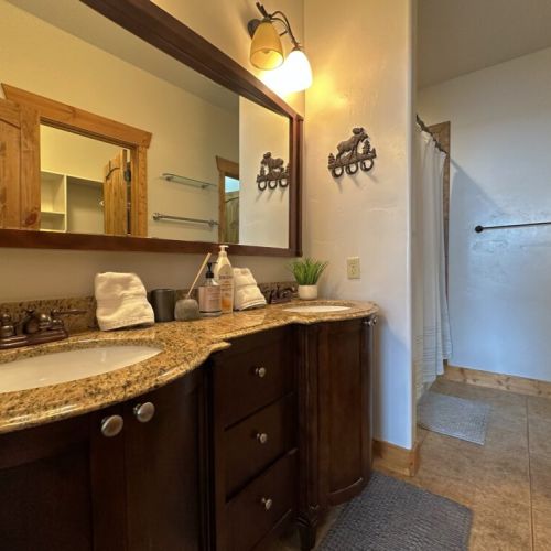 The master en suite bathroom has a large tub/shower combo, a spacious double vanity, and a private water closet.