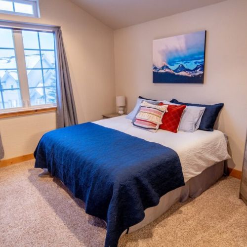 The master bedroom features a king bed, a dedicated work station with a computer monitor, and an en suite bath.