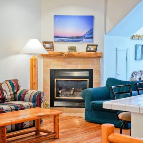 Cozy living room with fireplace and TV.