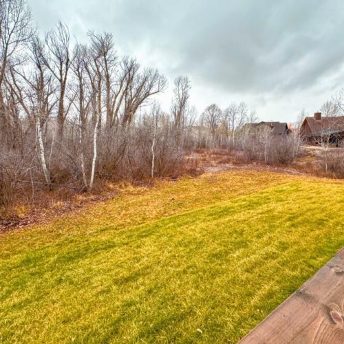 Head to the expansive back deck to enjoy a breath of fresh air and a lovely view of the nearby woods — animal sightings are frequent!